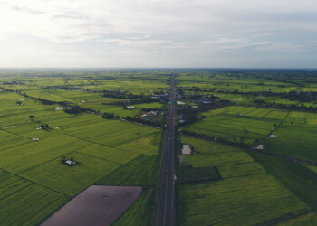 Aerial view over small village, Country roadside.